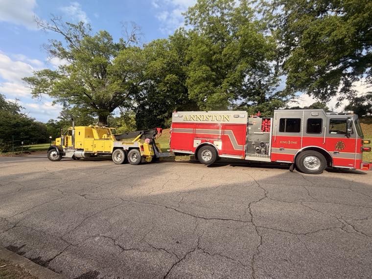 Heavy wrecker towing an Anniston fire engine