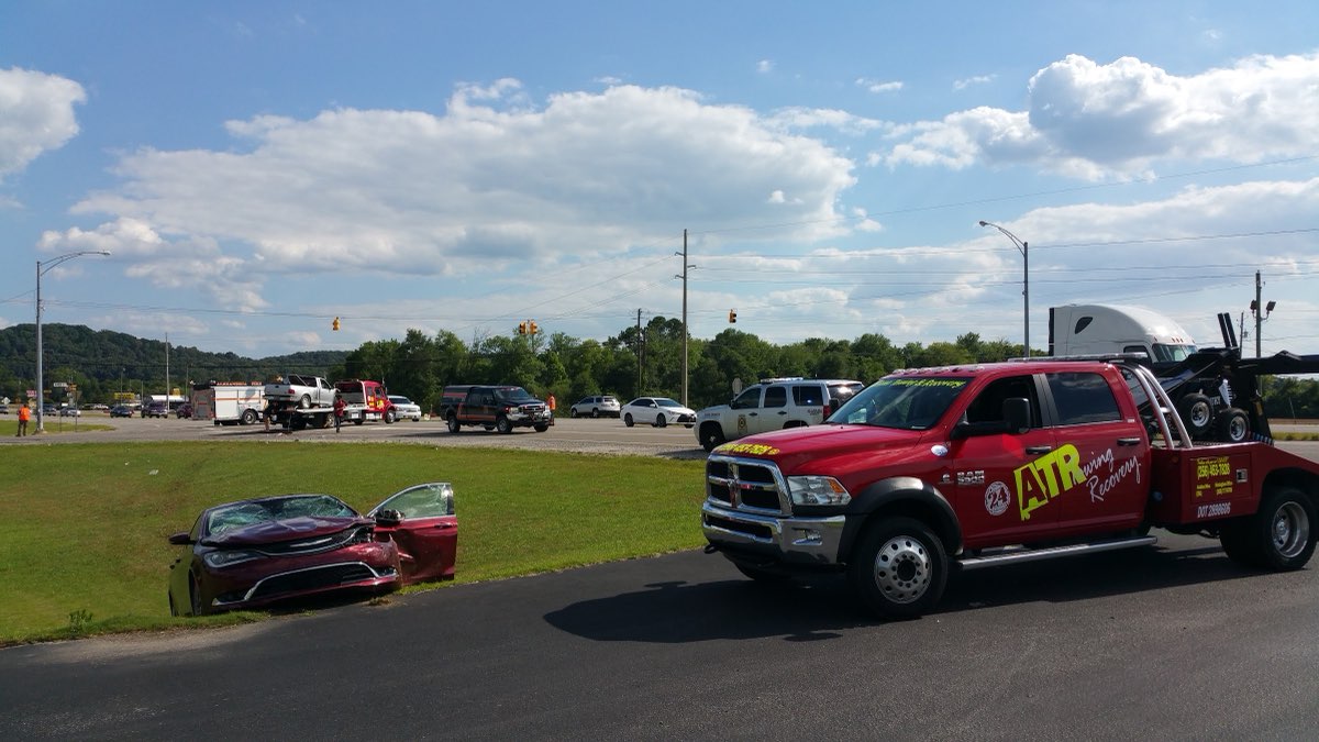 Alabama Towing & Recovery tow truck at a roadside accident scene in Anniston, Alabama